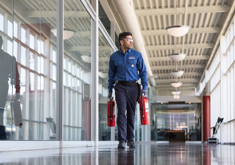 Cintas employee carrying fire extinguishers