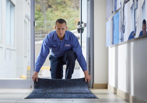 Cintas employee laying a mat