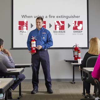 Two men talk about fire extinguisher training.