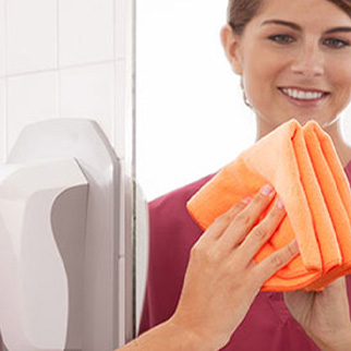 Woman using microfiber towel to clean mirror