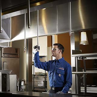 fire technician servicing kitchen suppression system