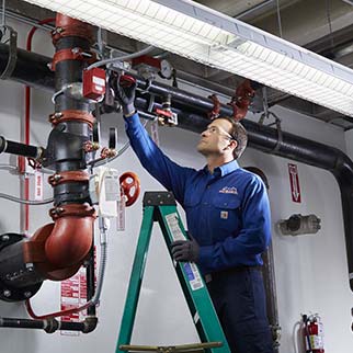 fire technician servicing sprinkler system