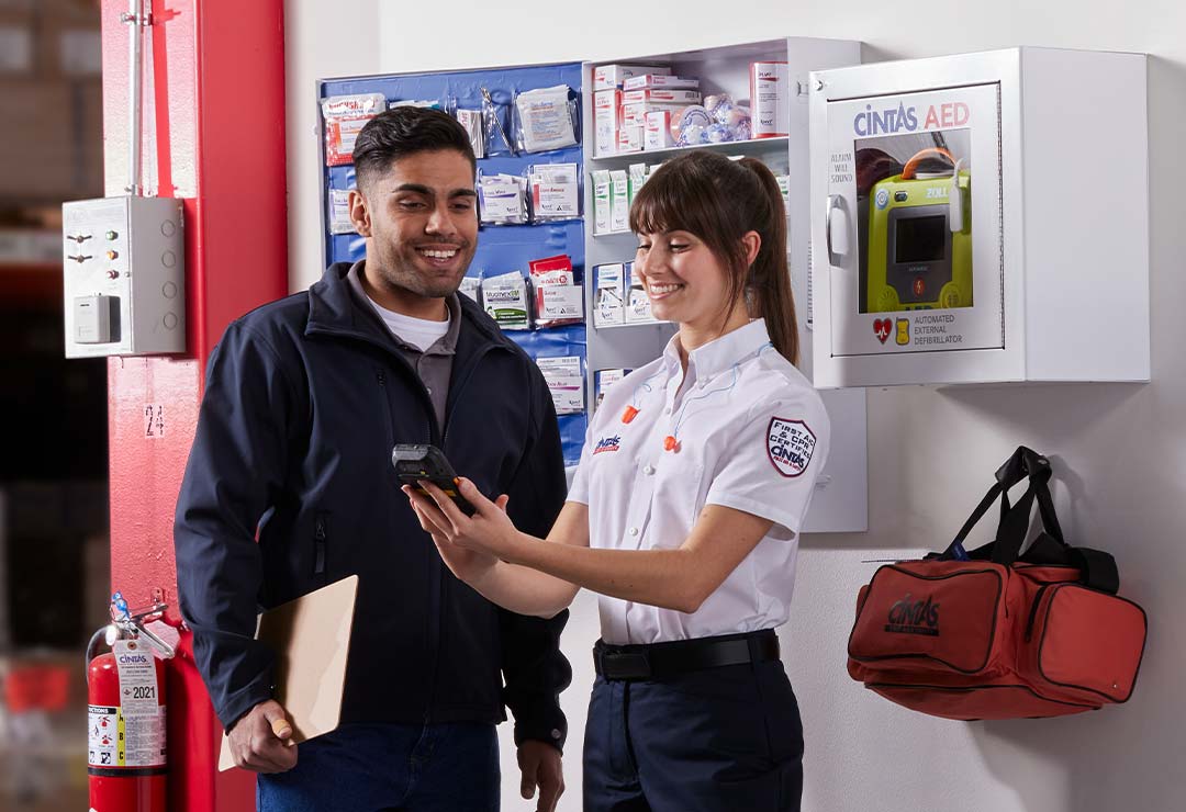 first aid representative helping customer with first aid cabinet