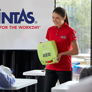 Cintas trainer holding an AED machine